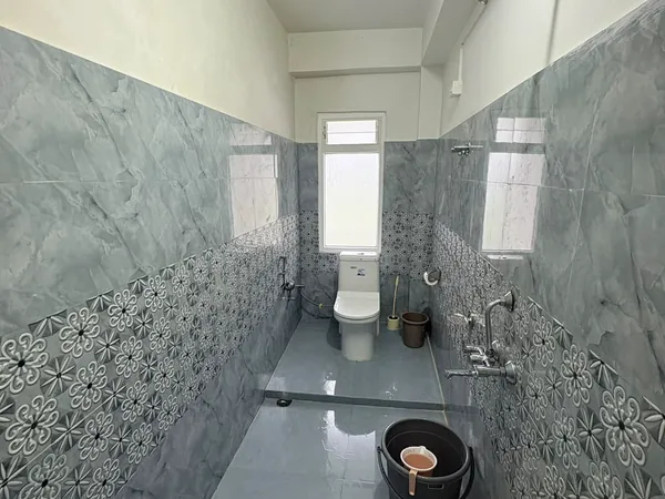 Tiled western-style washroom with a shower